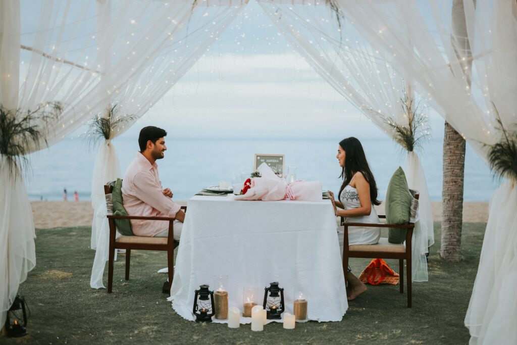Couple having a romantic dinner on the beach.