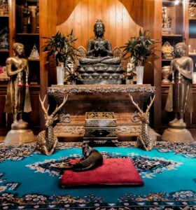 A living room with a rug and a statue